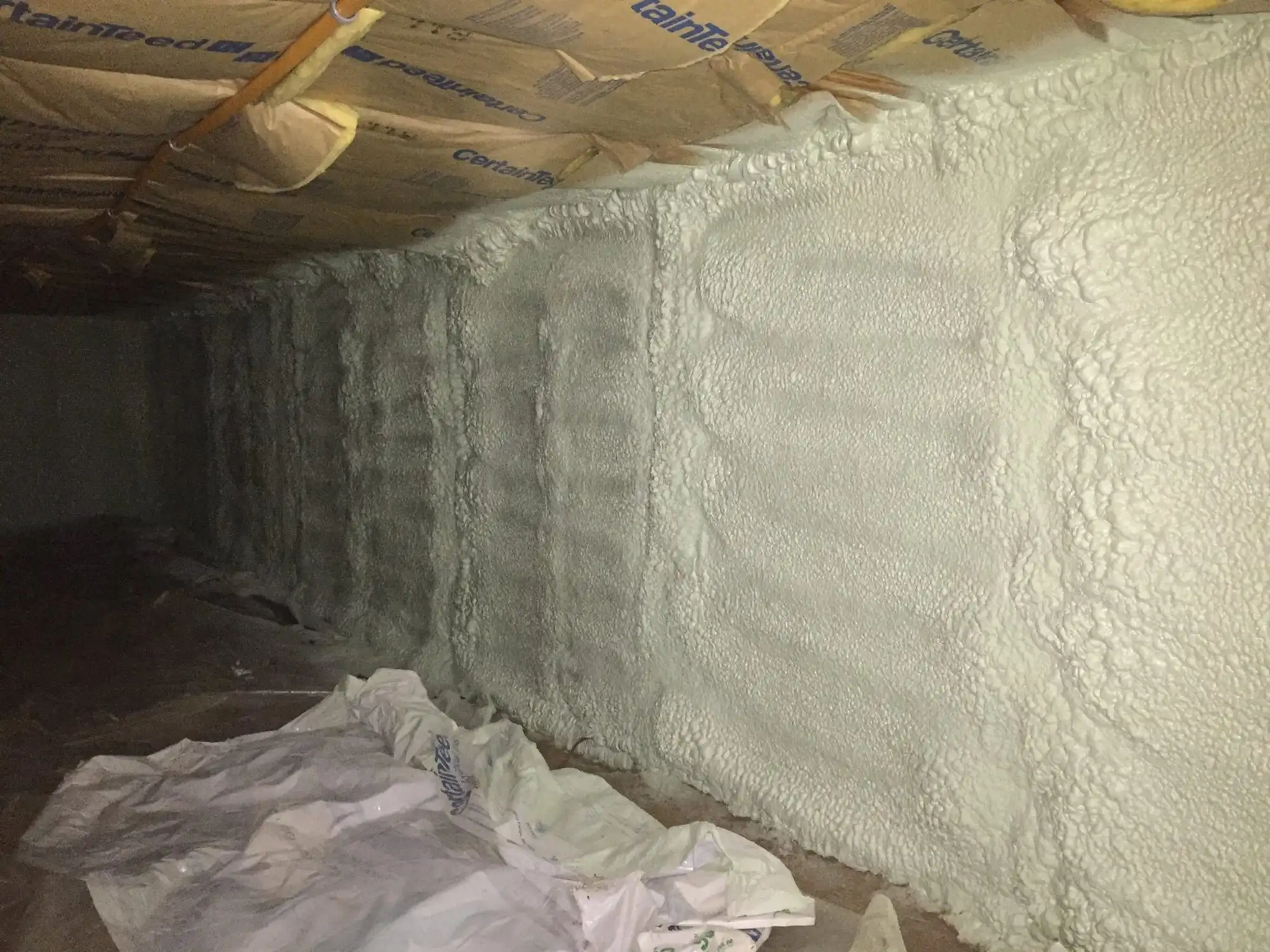 Spray foam insulation installed in a framed building assembly